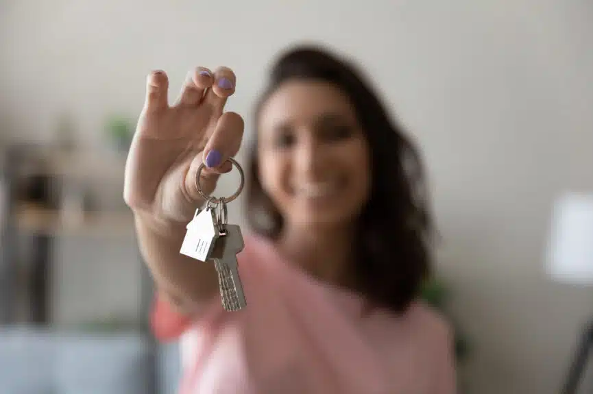 Person holding keys after purchasing their home thanks to the first-time homebuyers incentive.